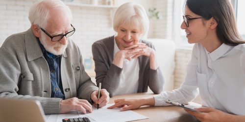 Consultant financial adviser specialist dealing with senior elderly grandparents couple clients, discuss health insurance, bank account history. Family spouses customers consult with relator broker.