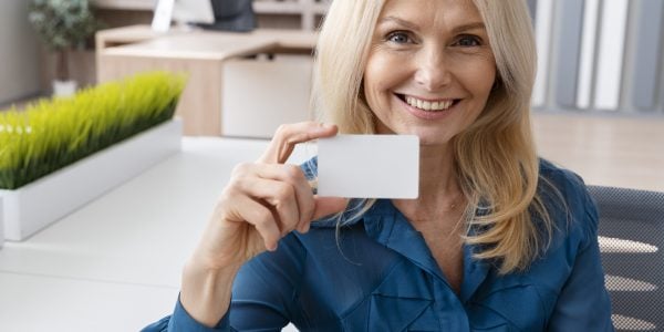smiley-woman-holding-business-card-medium-shot